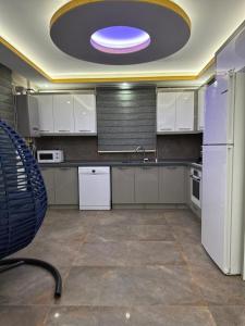 a kitchen with white appliances and a purple ceiling at Villa mila in Belek