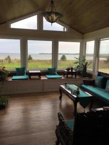 a living room with windows and a table and chairs at Lica’s house in Vernon Bridge