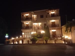 a building with lights in front of it at night at Kandania Apartments in Kántanos