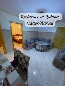 a living room with a couch and a table at Residence al Rahma 05 in Monte ʼArrouit