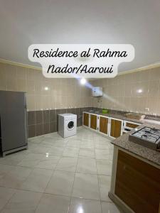 a kitchen with a washing machine in a room at Residence al Rahma 05 in Monte ʼArrouit