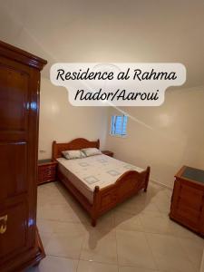 a bedroom with a bed in a room at Residence al Rahma 05 in Monte ʼArrouit