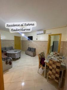 a living room with a couch and a table at Residence al Rahma 05 in Monte ʼArrouit