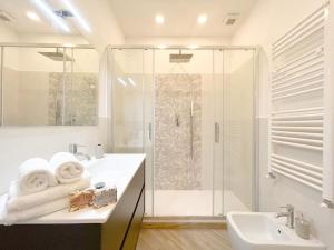 a white bathroom with a shower and a sink at [Lusso in Centro Storico] - WIFI - AC in Savona