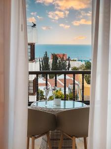 a table and chairs on a balcony with a view of the ocean at Sapphire Riviera Residence in Adeje