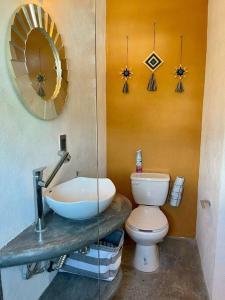 a bathroom with a toilet and a sink and a mirror at océano estudio 2 in Sayulita +23 photos