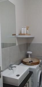 a white bathroom with a sink and a mirror at Villa Granito No 6, Paarl in Paarl