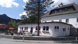 a group of people sitting outside of a building at Wengerwirt - die Laube in Weng im Gesäuse