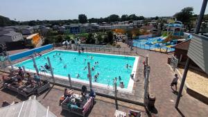 an overhead view of a swimming pool with people in it at The Nook, White Horse, Selsey in Selsey