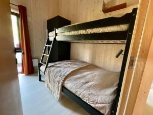 a room with two bunk beds with a ladder at Atlantic Panorama Lofoten in Leknes