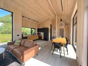 a living room and kitchen with a couch and a table at Atlantic Panorama Lofoten in Leknes