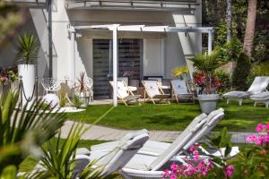 a group of lawn chairs in a yard at Majestique in Pobierowo