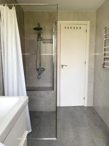 a shower with a glass door in a bathroom at Entre el verde y el azul in Fuengirola +17 photos