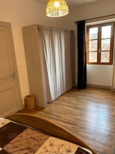 a living room with a surfboard on a wooden floor at La Vallée Claire in Le Blanc