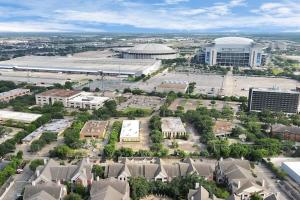 an aerial view of a large city with a building at Lux Mid-Rise Walking Distance to NRG Stadium in Houston