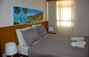 a bedroom with a large bed with white pillows at Apartamento a Beira Mar no Flat Elegance in Natal +42 photos