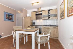 una cucina con tavolo e sedie in una stanza di Haus-Olymp-Wohnung-5-371 a Kühlungsborn