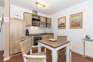 una cucina con tavolo e sedie in una stanza di Haus-Olymp-Wohnung-5-371 a Kühlungsborn