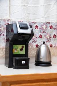 a coffee maker and a tea kettle on a counter at Dette's Nook in Roseau