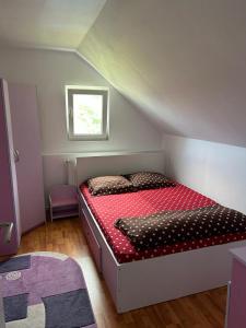 a small bedroom with a bed in a attic at Cabana Vladimir in Cucuceni