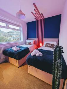 a bedroom with two beds and a cactus at 4Bedroom house Manchester-Centre/Hospital/Motorways/Uni in Manchester