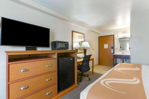 a hotel room with a bed and a flat screen tv at Quality Inn Hamilton Bitterroot Valley in Hamilton