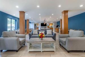 a living room with two couches and a table at Quality Inn & Suites Chattanooga West near Lookout Mountain in Chattanooga