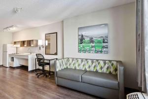 a living room with a couch and a desk and a kitchen at Extended Stay America Suites - Fremont - Newark in Fremont