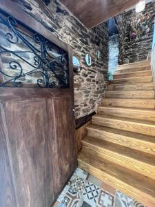 a staircase in a house with a wooden door at El Rincón del Val 