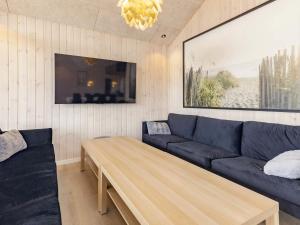a living room with a blue couch and a table at Luxury Retreat in Marielyst - By Traum Ferienwohnungen in Marielyst