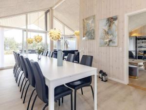 a dining room with a white table and chairs at Luxury Retreat in Marielyst - By Traum Ferienwohnungen in Marielyst