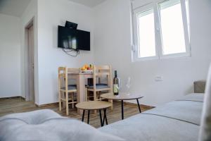 a living room with a table and chairs and a tv at Premium Apartments in Žabljak