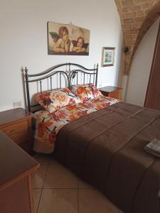 a bedroom with a bed with a comforter on it at B&B LA BOUGANVILLE in Spoltore
