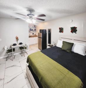 a bedroom with a large bed and a kitchen at Adorable Mini Suite in Tampa in Tampa