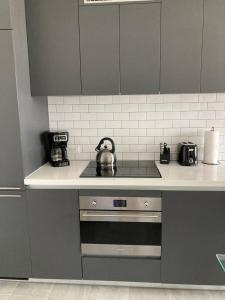 a kitchen with a stove with a tea kettle on it at Brand NEW modern 1 bedroom unit Downtown in Miami