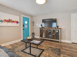 a living room with a couch and a tv at Heart of Westport 1BR in Kansas City