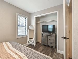 a bedroom with a bed and a tv and a mirror at Heart of Westport 1BR in Kansas City