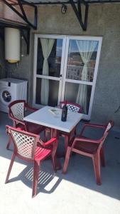 a picnic table with two chairs and a bottle of wine at APARTAMENTO C. LA VILLA TEO in Las Lagunas