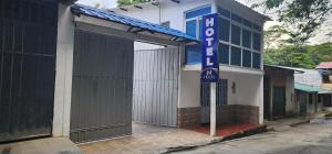 un edificio con una puerta abierta con un cartel. en Hotel Noz INN, en Villavicencio