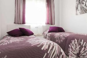 Postel nebo postele na pokoji v ubytování Apartment Aguila Real + 10 fotografií