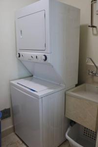 a small white bathroom with a sink and a dryer at 13B Spectacular Oceanview Resort Lifestyle Panama in ArraijÃ¡n