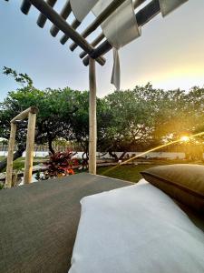 a bedroom with a bed under a pergola at Pantai Atins in Atins