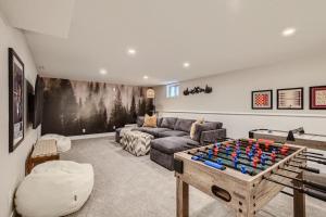 a living room with a couch and a foosball table at Heights Hideaway - Great Location - Game and Movie Room in Westminster