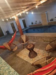a group of chairs and a table and a pool at CasaBongo, alojamiento vacacional con piscina in Honda