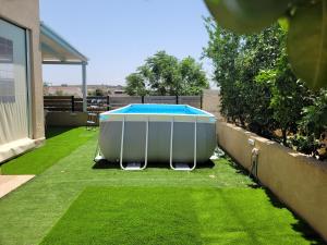 a hot tub sitting on top of a lawn at Assaf's place - המקום של אסף in Aẖihud