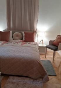 a bedroom with a bed and a chair at Park 1 MARKO FREE PARKING in Vranje