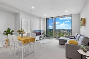 a living room with a table and a couch at Entire Apartment in Ryde in Sydney