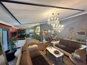 a living room with a couch and a chandelier at Luxury House City Center in Trabzon
