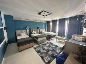 a living room with two beds and a couch at Luxury House City Center in Trabzon