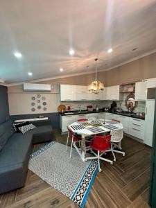 a kitchen with a table and red chairs in a room at Luxury House City Center in Trabzon